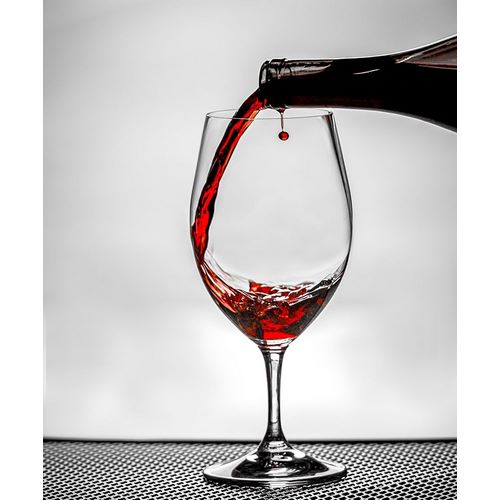 Washington State-Spokane Red wine poured into wine glass creates perfect round drop,